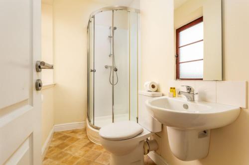 a bathroom with a toilet and a sink and a shower at Elliot Suite No15 - Donnini Apartments in Ayr