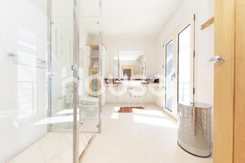 a bathroom with a glass shower and a toilet at Villa Tarifa in Tarifa