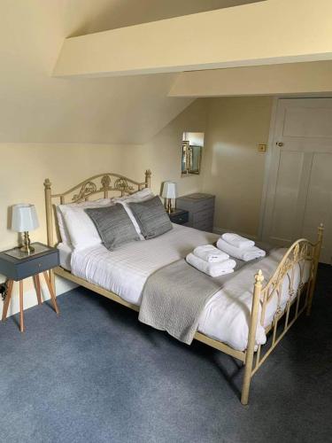 a bedroom with a large bed with two towels on it at The Gables in Hunstanton