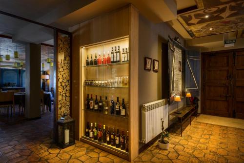 a room with a display of bottles of alcohol at Hotel La Casueña in Lanuza