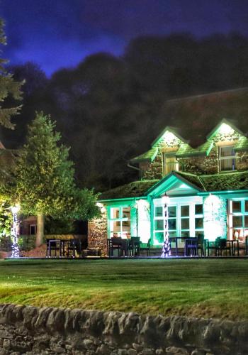 a house lit up at night with lights at Westlands of Pitlochry in Pitlochry
