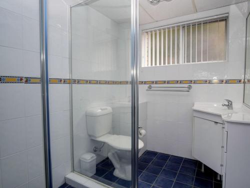 a bathroom with a toilet and a sink and a shower at Anchorage 7 in Tuncurry