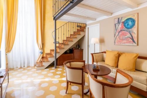 a living room filled with furniture and a stairway at Locanda Il Maestrale in Monterosso al Mare