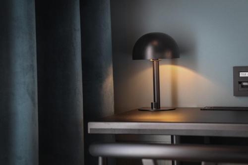 a lamp sitting on a table in a room at Best Western and Hotel Linkoping in Linköping