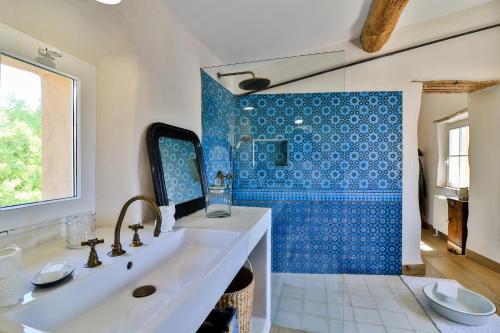 a bathroom with a sink and a blue tile shower at La Maison Long - Côté Nougat in Ollioules