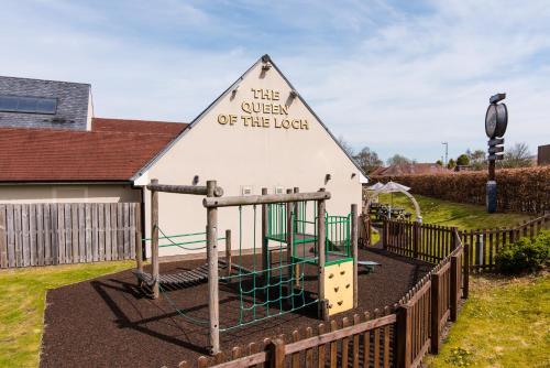 a building with a playground in a yard at Queen of the Loch, Balloch by Marston's Inns in Balloch