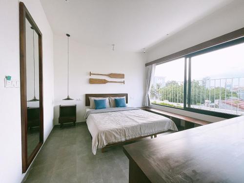 Ένα ή περισσότερα κρεβάτια σε δωμάτιο στο NGÔ Homestay Phan Thiết