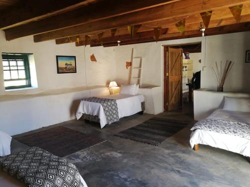 a bedroom with two beds in a room at Klipfontein Rustic Farm & Camping in Tulbagh