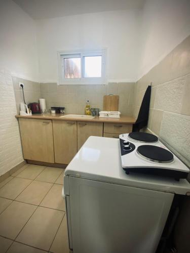 a kitchen with a white stove top oven on a counter at Dream On The Sea Of Galilee in Tiberias