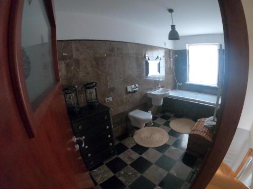a bathroom with a sink and a toilet and a mirror at Apartament Magdaleentje in Gdańsk