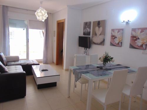 a living room with a table and a dining room at Apartamentos varios con 2 dorm en Marina Dor , la playa de Amplaries 47 , vista lateral al mar in Oropesa del Mar