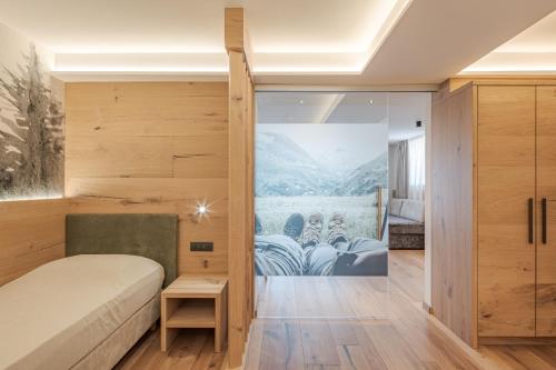 a bedroom with a bed and a sliding glass door at Hotel Bellavista in Cavalese