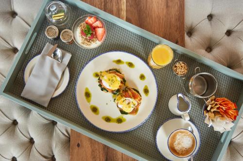 a table with a plate of breakfast food on it at Riva Boutique Hotel in Helensburgh