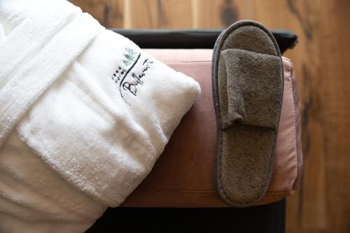 a towel and a napkin sitting on top of a suitcase at Hotel Bellavista in Cavalese