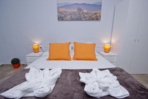 a bedroom with a bed with two towels on it at Barcelona City Seven Hostal in Barcelona