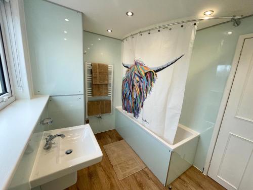 a bathroom with a sink and a painting on the wall at Shepherd Moon in Talmine