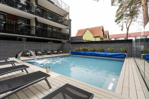 a swimming pool in front of a building at Rezydencja Morski Tygiel in Łeba