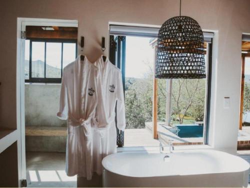 a mannequin standing next to a sink in a bathroom at De Uijlenes in Gansbaai