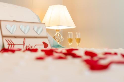 a table with two glasses of wine and a lamp at Villas at Aguada Sea Beach in Aguada