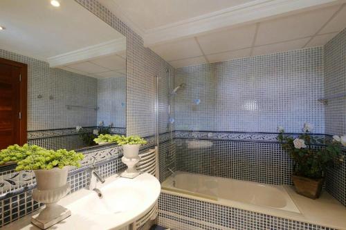 a bathroom with a sink and a bath tub at Villa Northern Star in Alcudia