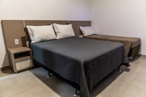 Ένα ή περισσότερα κρεβάτια σε δωμάτιο στο Pousada Show Park