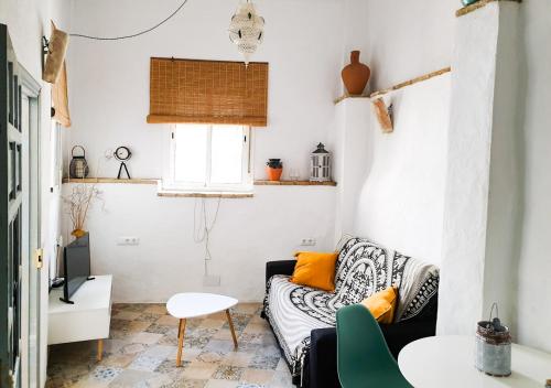 a living room with a couch and a table at Ojalá... in Vejer de la Frontera