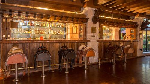 a bar with a bunch of chairs in front of it at Holiday Inn Queretaro Centro Historico by IHG in Querétaro