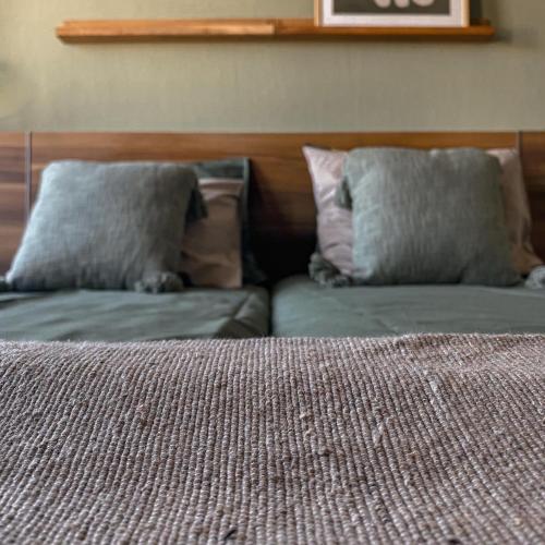 sypialnia z 2 poduszkami na górze łóżka w obiekcie B&B Mol w mieście Katwijk aan Zee