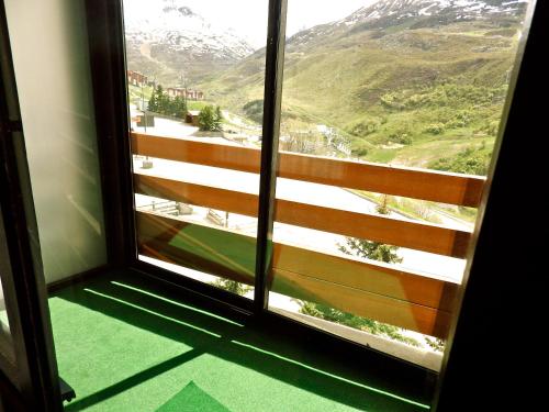 a window with a view of a mountain view at Résidence Chanteneige - Freeloc Immobilier in Les Menuires