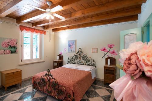 1 dormitorio con 1 cama, ventana y flores en Villa Mari, en Montagnana