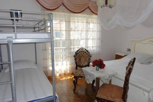 a bedroom with two bunk beds and a table and chairs at Croatia Zadar Borik big Family Apartment with garden view Number 6 in Zadar