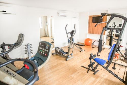 a gym with several treadmills and exercise bikes at Iate Hotel Centro Florianópolis in Florianópolis
