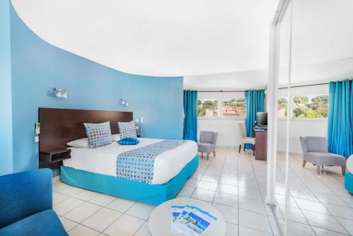 a hotel room with a bed with blue walls at La Fr&eacute;gate in Collioure