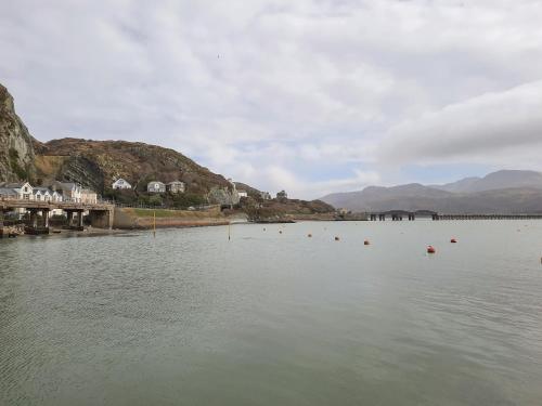 a large body of water with mountains in the background at Sapphire Suite in Barmouth