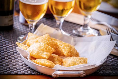 a basket of food on a table with glasses of wine at Aparthotel Adagio London Sutton Point in Sutton