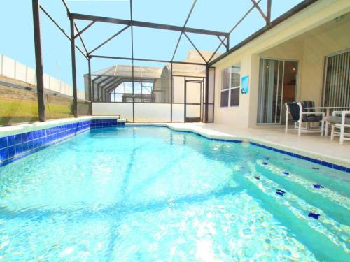 a swimming pool with blue water in a house at 4 Bed 2245 in Kissimmee