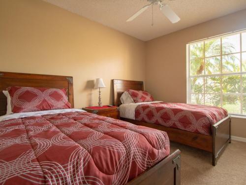 a bedroom with two beds and a window at 3 Bed 258 in Kissimmee