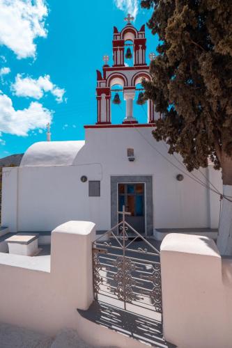 a gate in front of a building with a tower at Blue Soul Luxury Villa in Éxo Goniá
