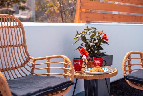two chairs and a table with a plate of food at Blue Soul Luxury Villa in Éxo Goniá