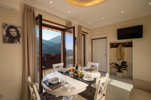 a dining room with a table and a large window at Donna Sofi Holiday House in Agerola