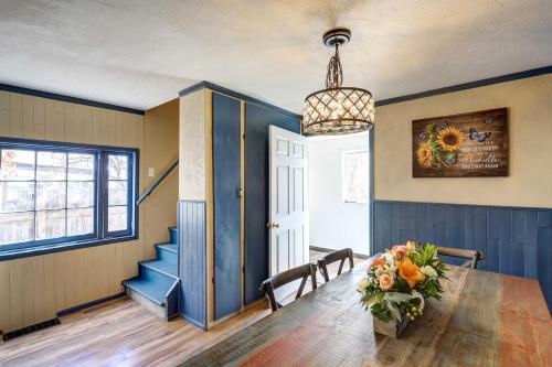 a dining room with a table and a chandelier at Charming Montrose Family Home Block to Downtown! in Montrose