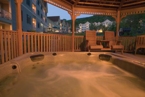 a hot tub on the deck of a house at Club Wyndham Bentley Brook in Hancock