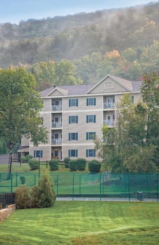 a large apartment building with a field of grass at Club Wyndham Bentley Brook in Hancock