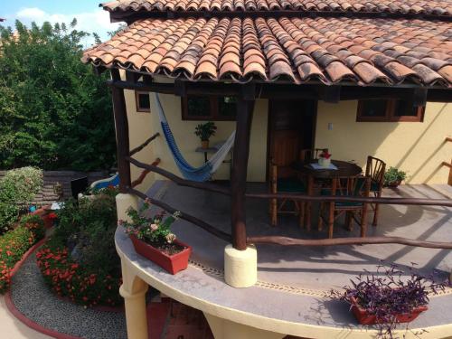 a small house with a table and a roof at Troncones Point Hostel in Troncones