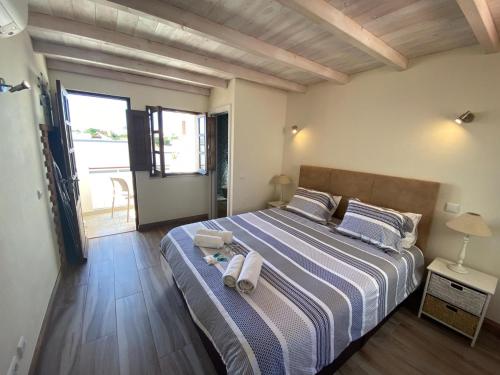 a bedroom with a bed with two towels on it at Lagos Center House in Lagos