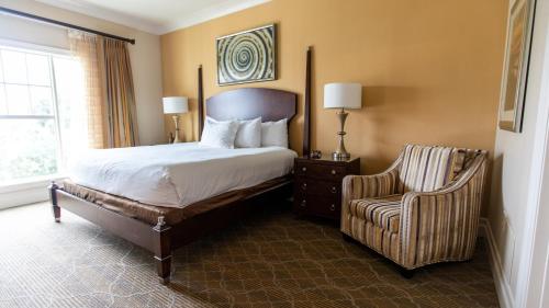 a hotel room with a bed and a chair at Holiday Inn Club Vacations South Beach Resort in Myrtle Beach