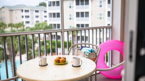 a table with a plate of food on a balcony at Holiday Inn Club Vacations South Beach Resort in Myrtle Beach