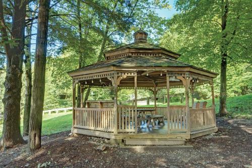 a wooden gazebo with a table and benches in a park at Club Wyndham Bentley Brook in Hancock