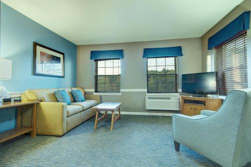a living room with a couch and a tv at Club Wyndham Bentley Brook in Hancock