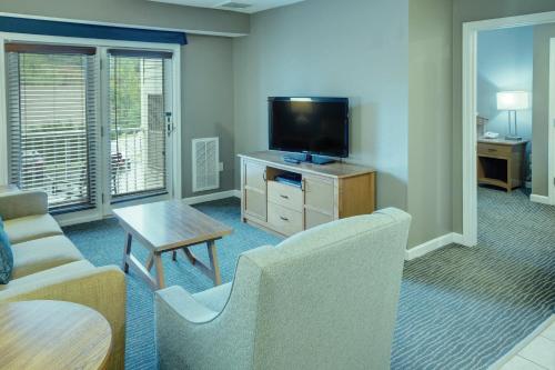 a living room with a couch and a tv at Club Wyndham Bentley Brook in Hancock